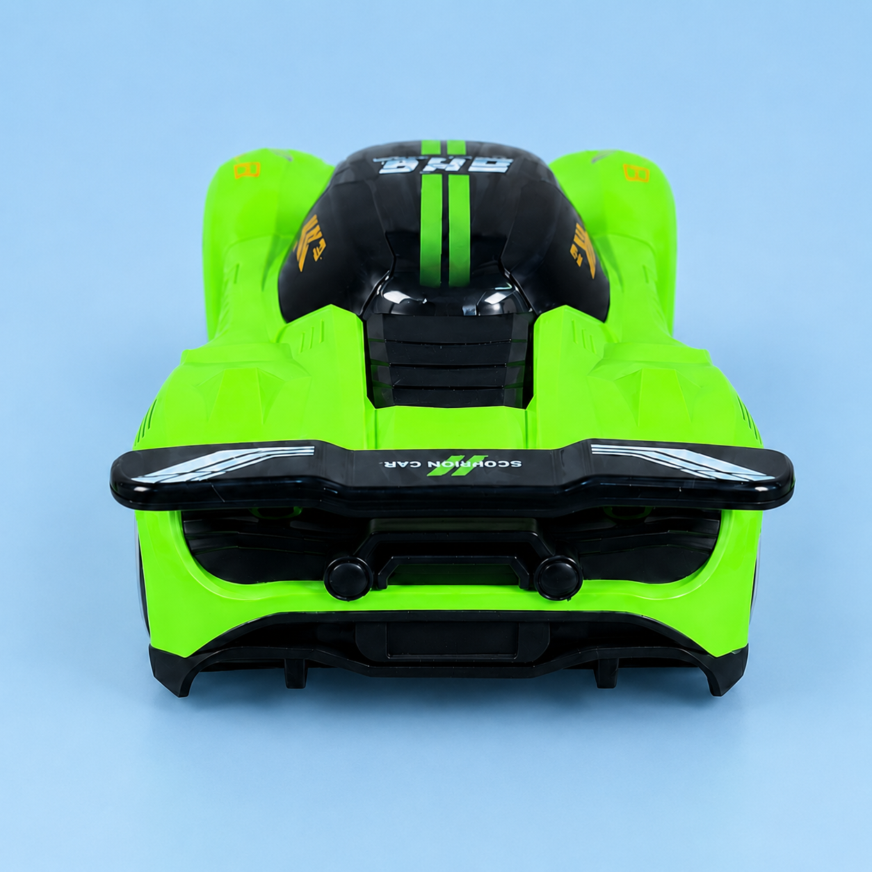 A bright neon green and black toy race car shown from the rear, featuring a glossy black rear spoiler, dual exhausts, and racing decals, set against a solid light blue background.