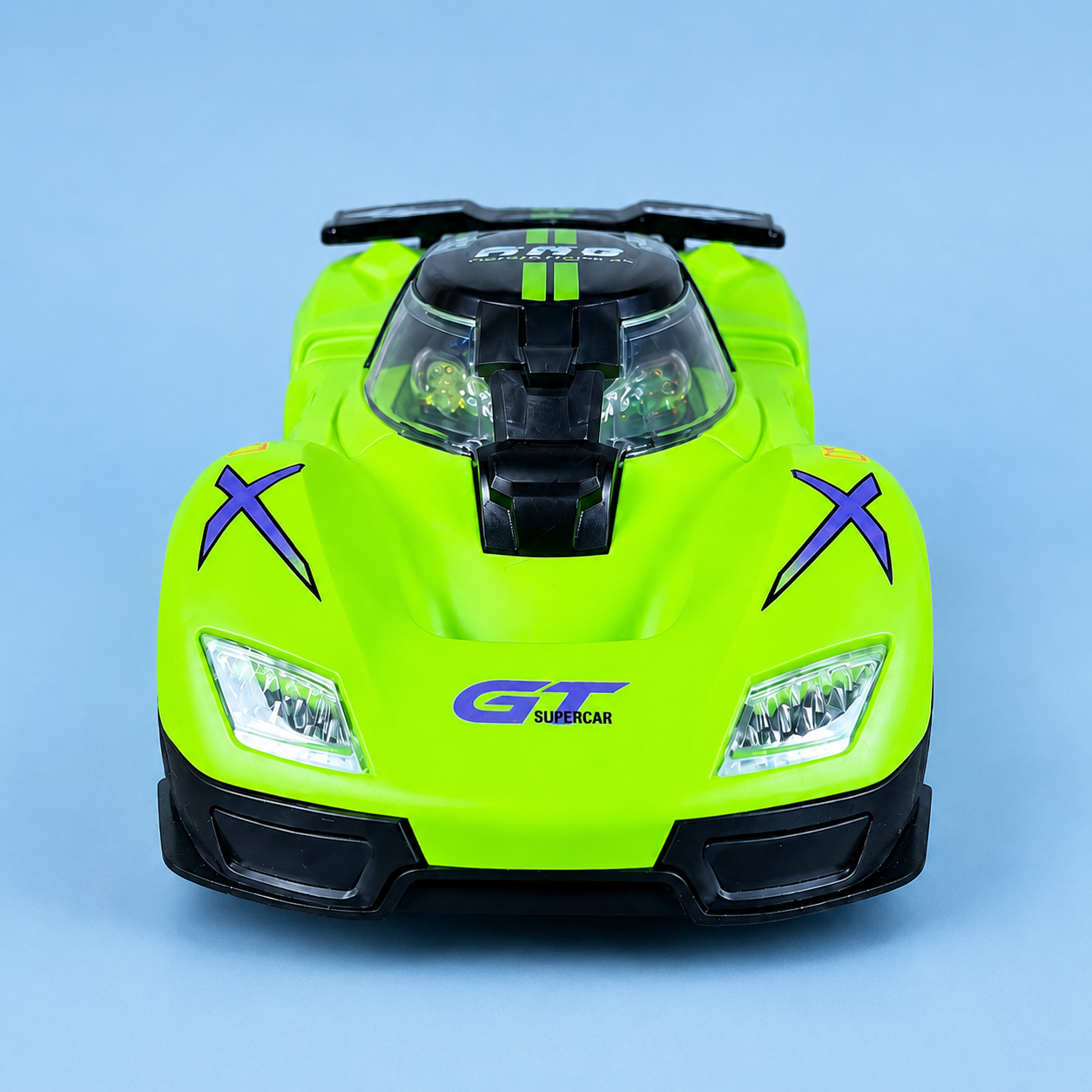 A bright lime green toy supercar with black accents, purple 'X' decals on the fenders, and 'GT SUPERCAR' printed on the front, photographed from the front against a solid light blue background.